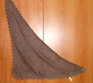 A downy open-work 3-cornered scarf